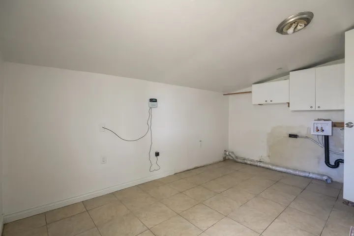 Laundry room featuring vaulted ceiling, cabinet space, and hookup for a washing machine