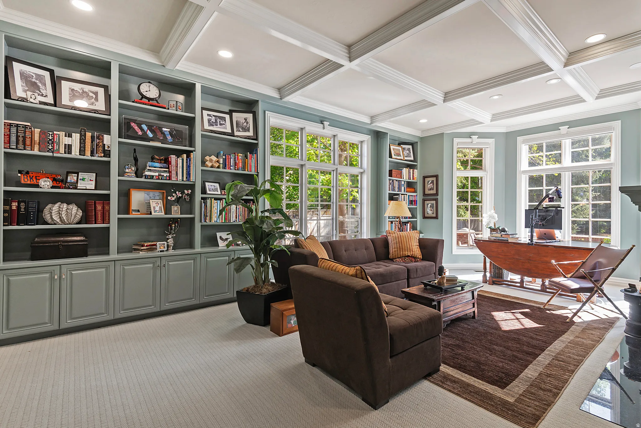 Lovely library featuring coffered ceiling, crown molding, carpet flooring, recessed lighting, and so many custom built-ins