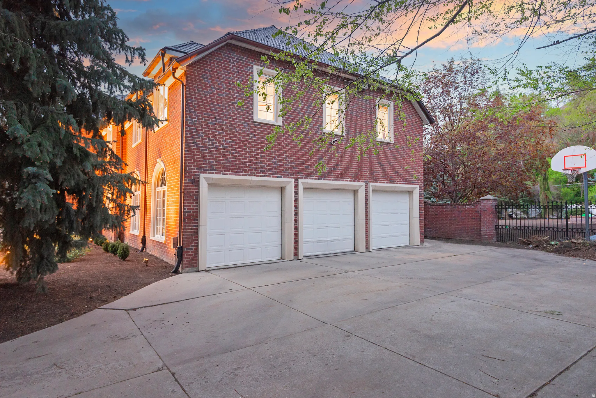 3 car oversized side-entry garage and large courtyard with basketball standard.