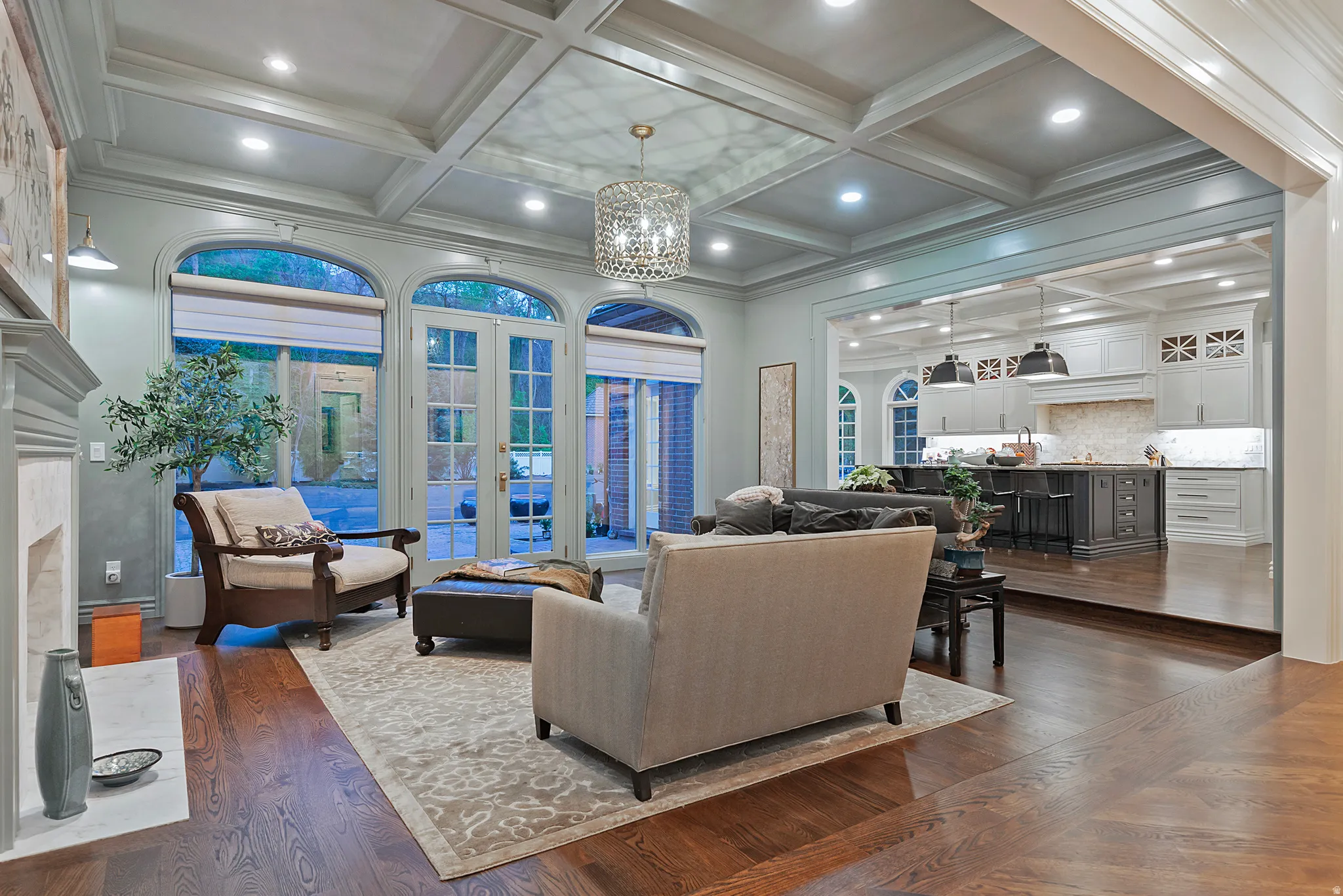 Charming family room off of kitchen w/coffered ceiling, French doors, and a cozy fireplace