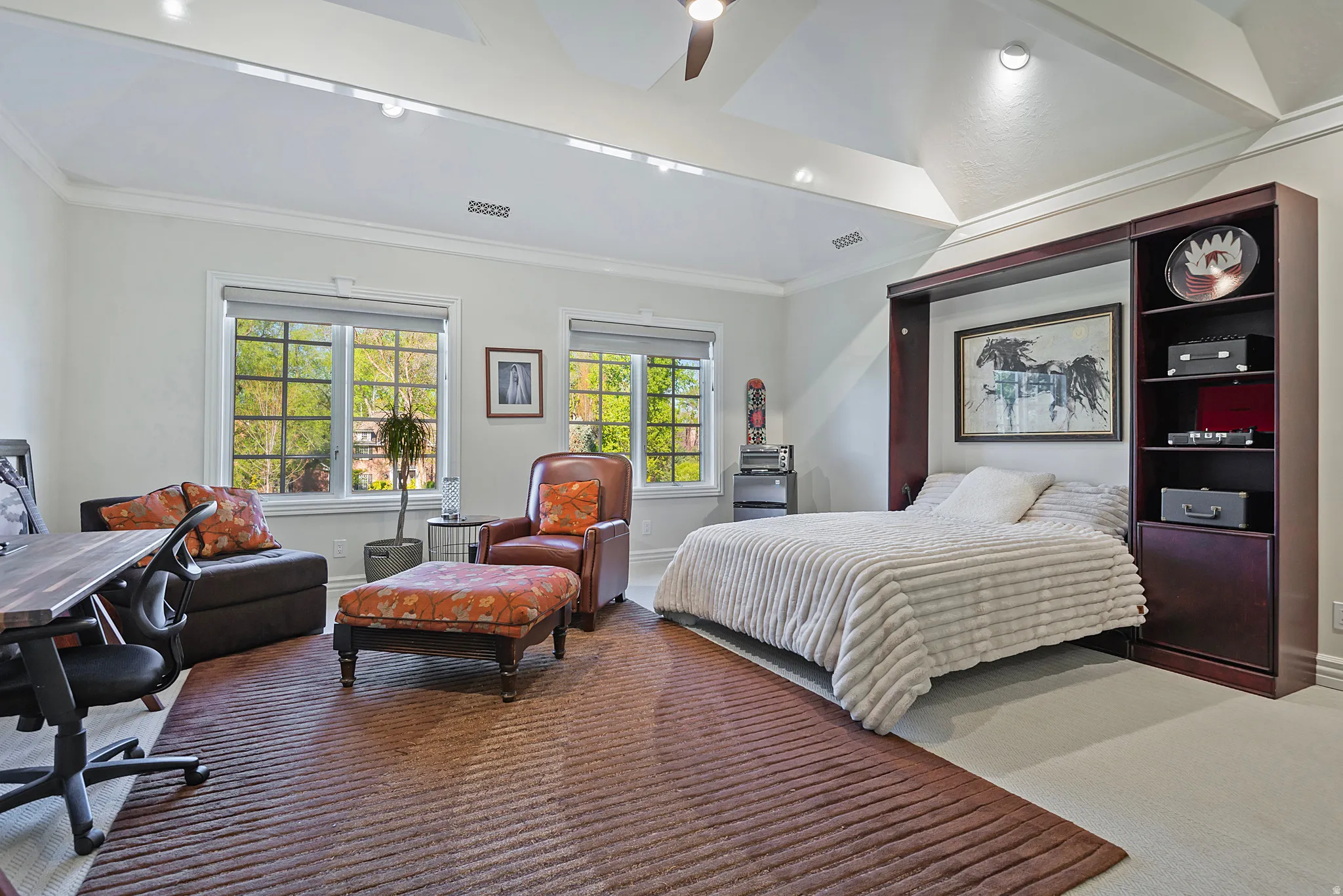 Large bedroom featuring crown molding, a ceiling fan, and carpet floors