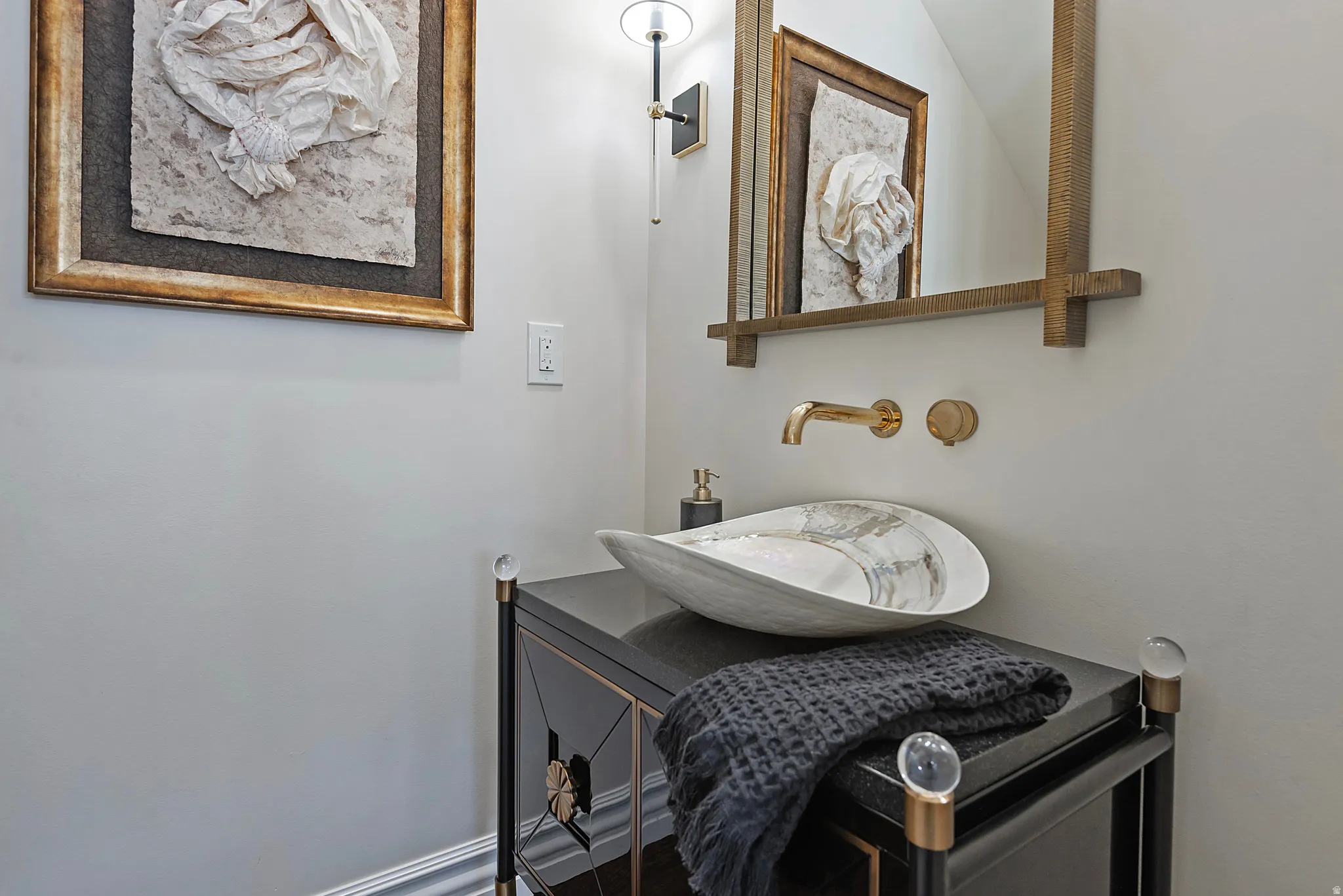 Two guest half baths are each unique and clever fixtures.