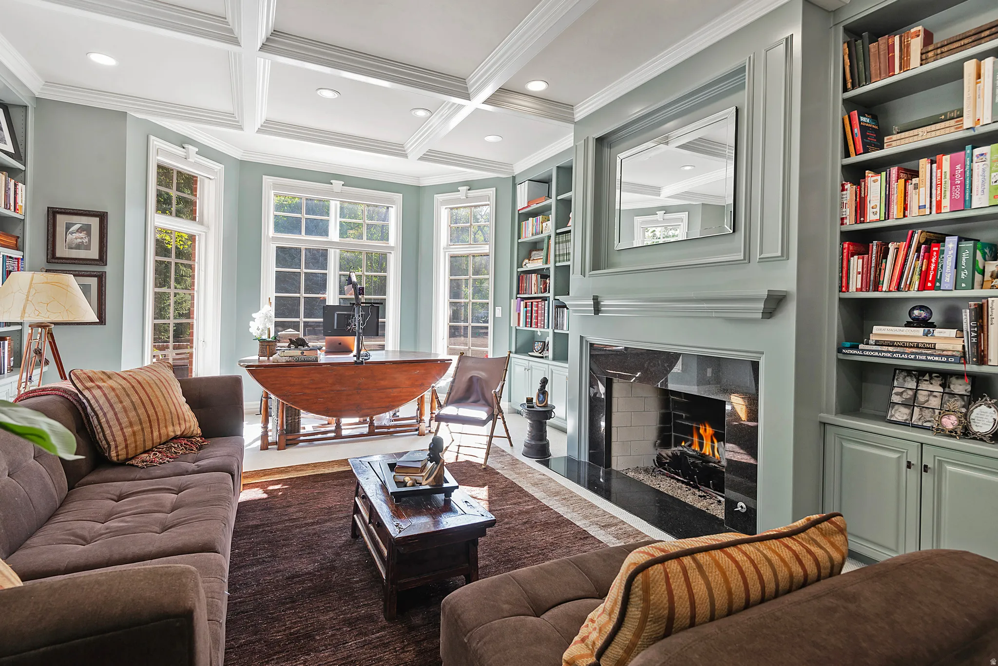 Lovely library featuring coffered ceiling, crown molding, carpet flooring, recessed lighting, and so many custom built-ins
