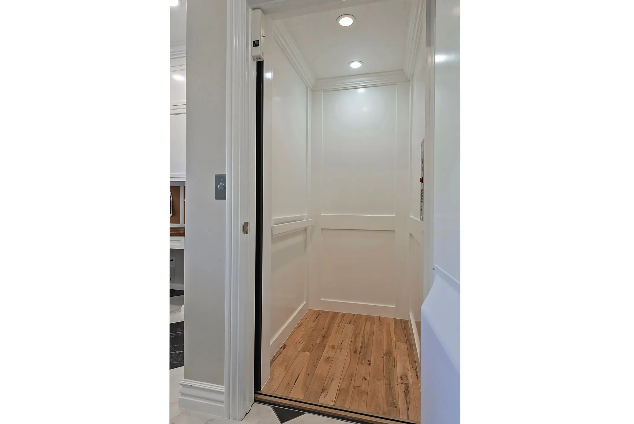 Elevator with ornamental molding, recessed lighting, and wood finished floors