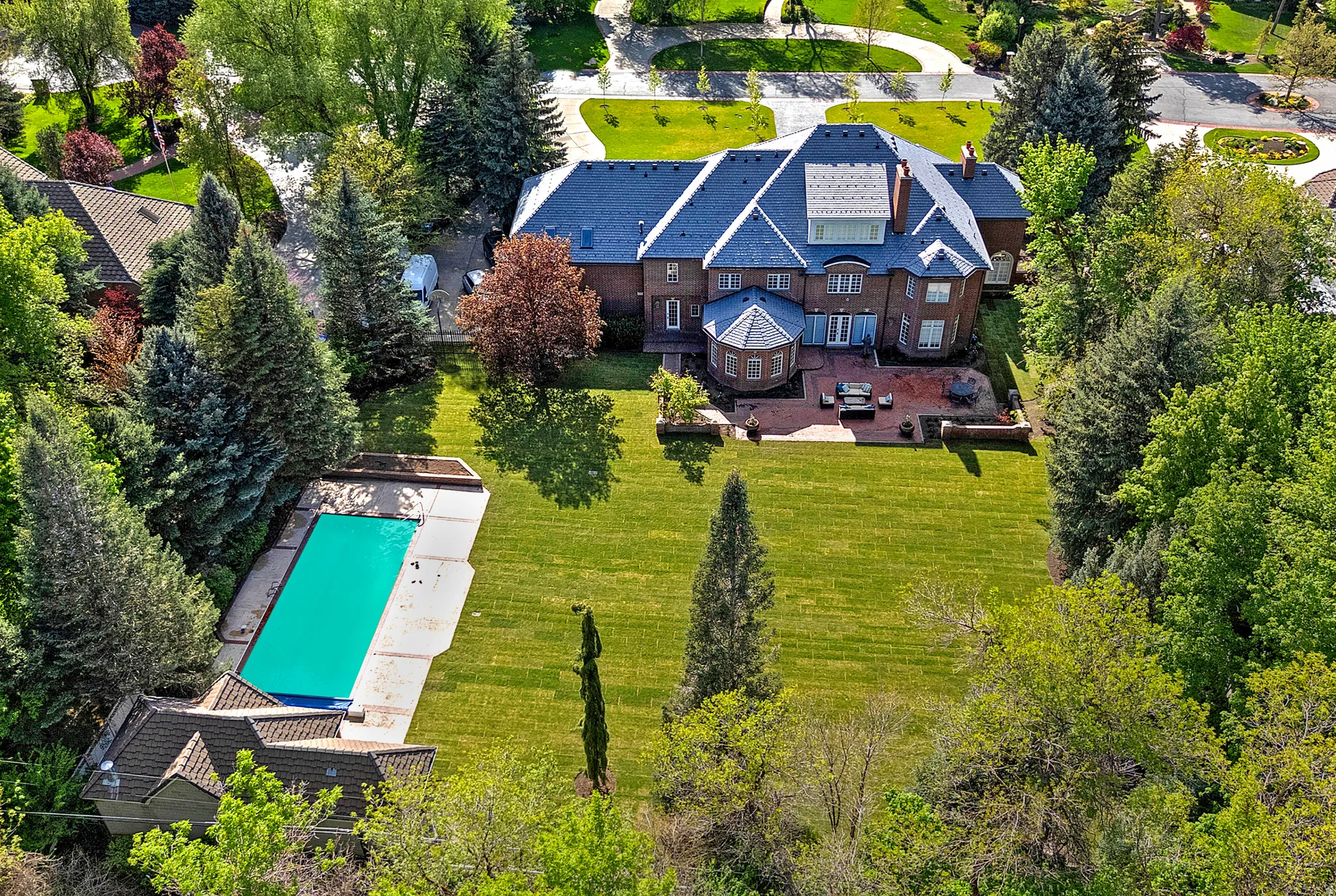 Aerial view of property and surrounding area with a pool, pool house and privacy!