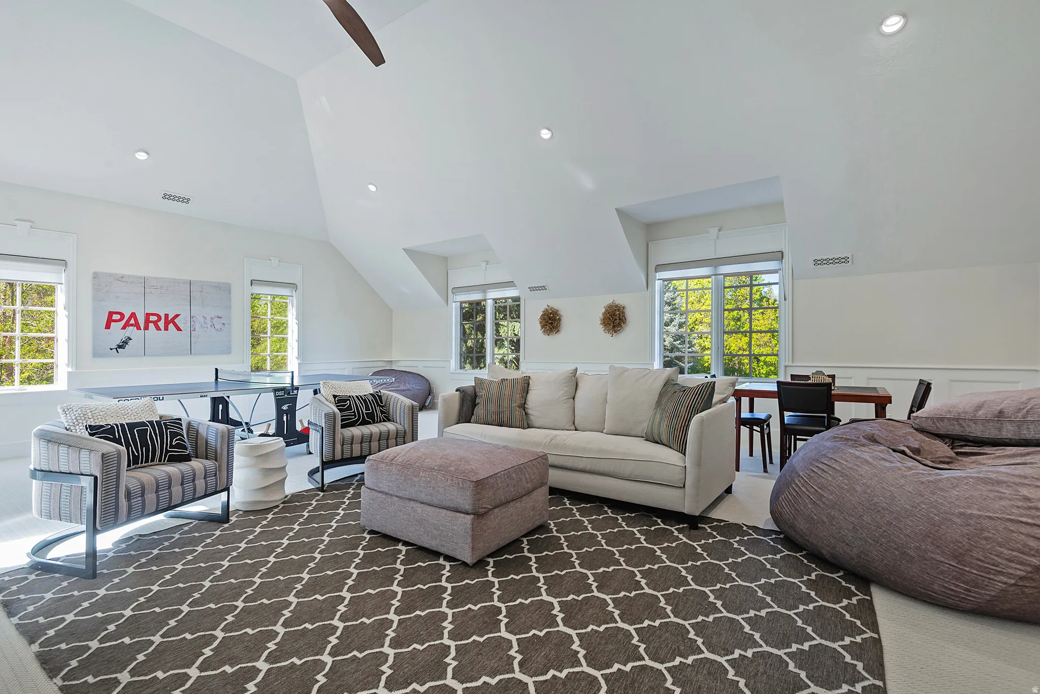 Great game room with lofted ceiling, ceiling fan, recessed lighting, and a wainscoted wall - room for pool table, ping pong and more