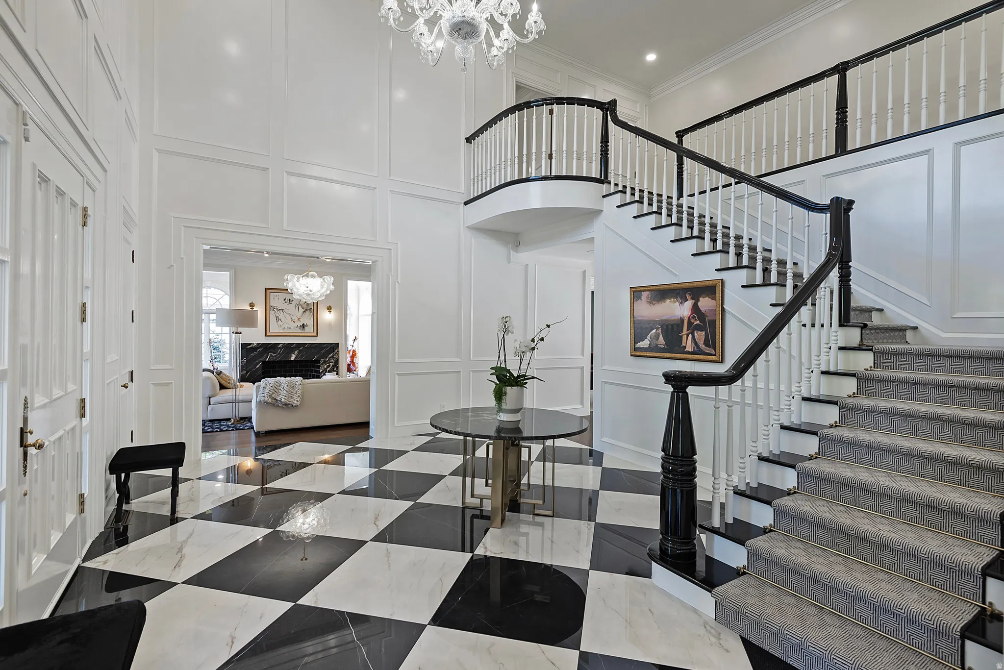 Exquisite and elegant foyer entrance with vaulted ceiling, stunning chandelier and a grand sweeping staircase.