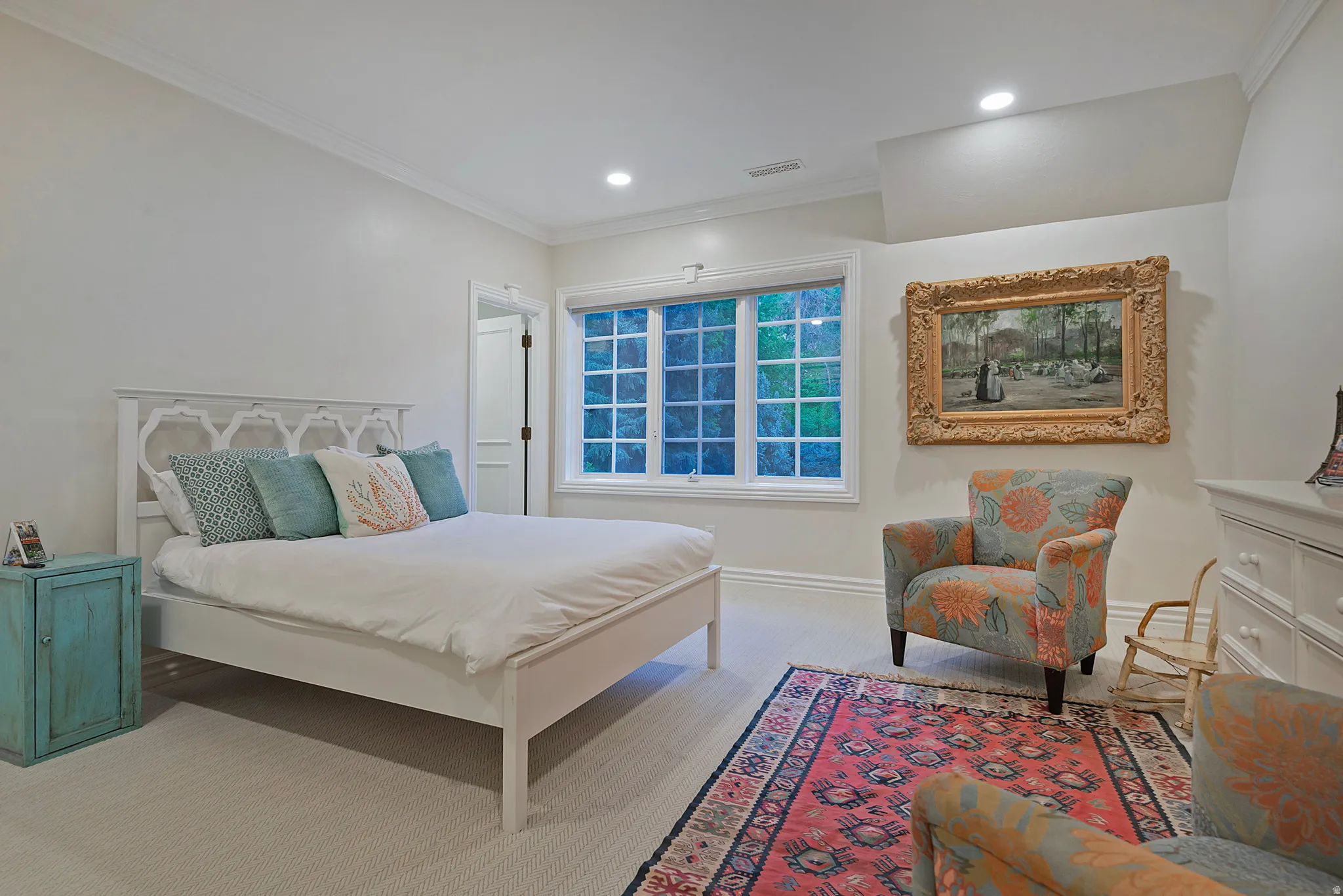 Spacious ensuite bedroom with ornamental molding, light colored carpet, and recessed lighting