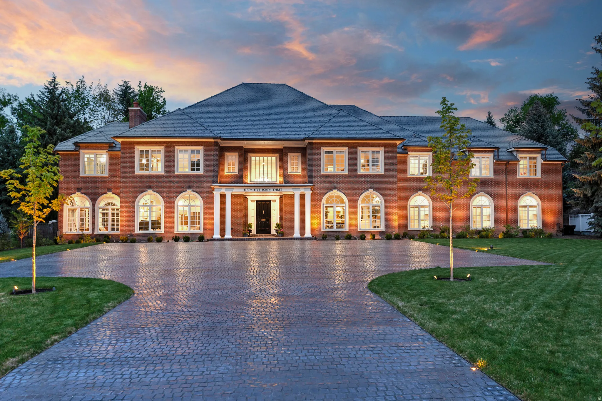 New paver courtyard and drive offers charm and so much extra parking!