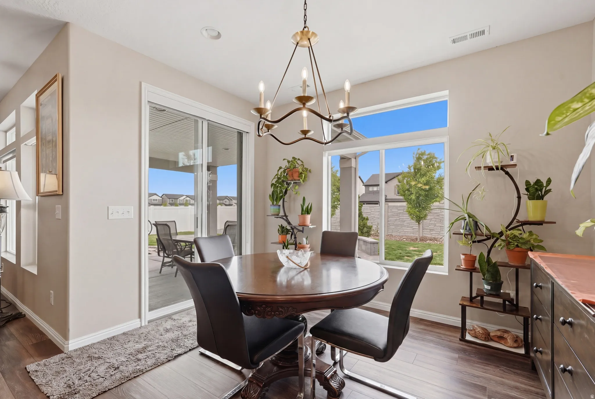 Dining area featuring hanging lights and dark wood-type flooring