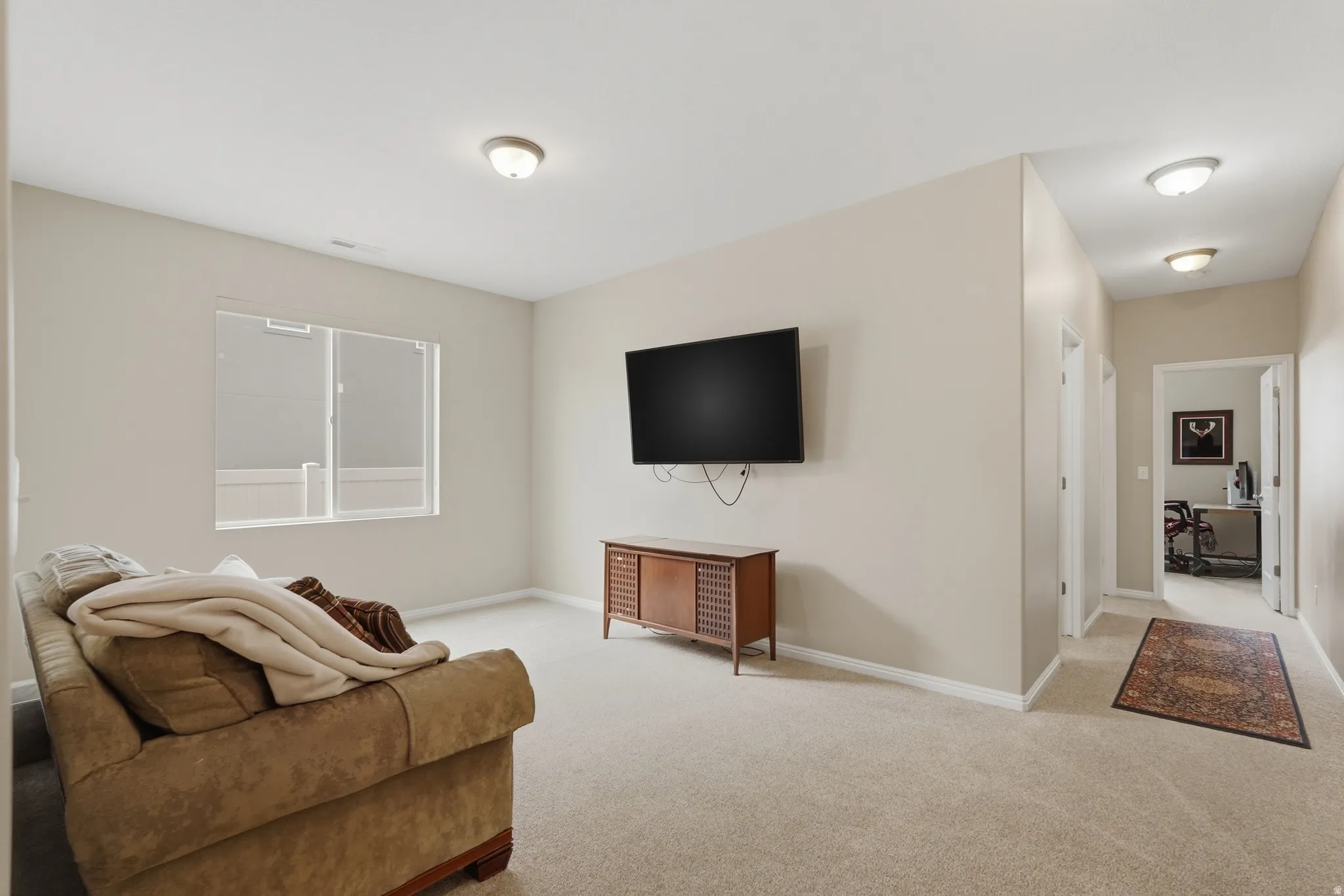 Living room with light carpet and baseboards