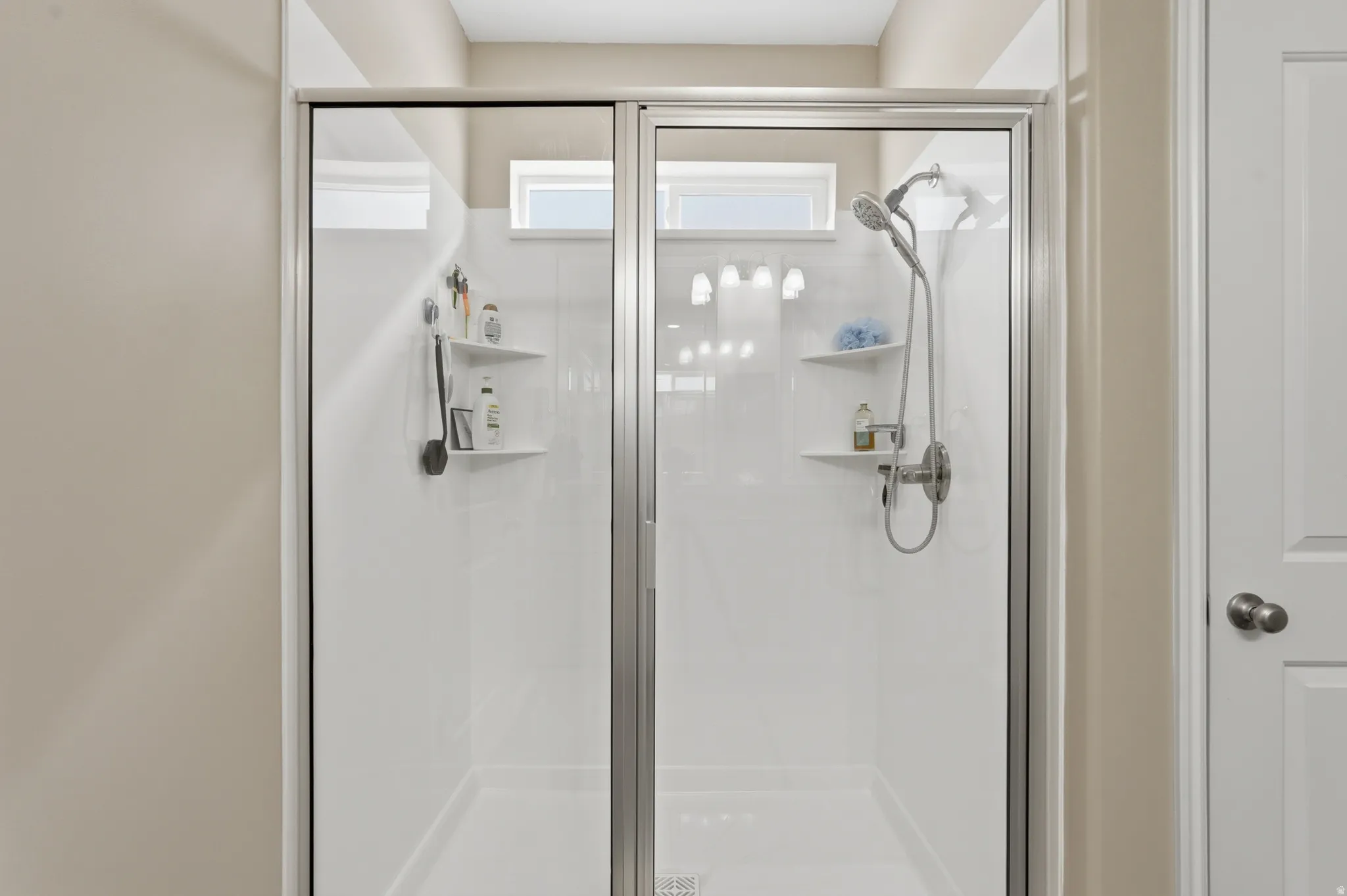 Full bath featuring a shower stall