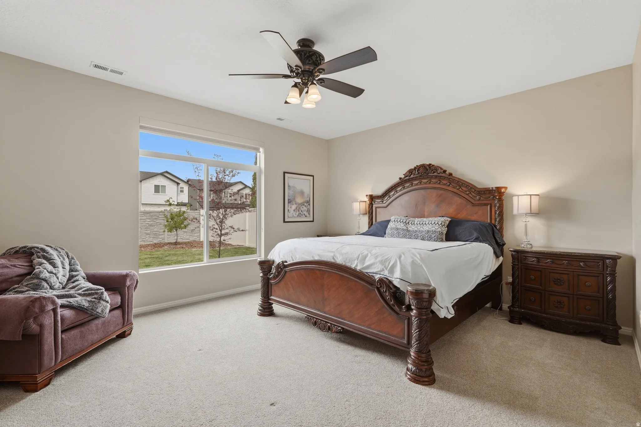 Bedroom featuring light carpet and a ceiling fan