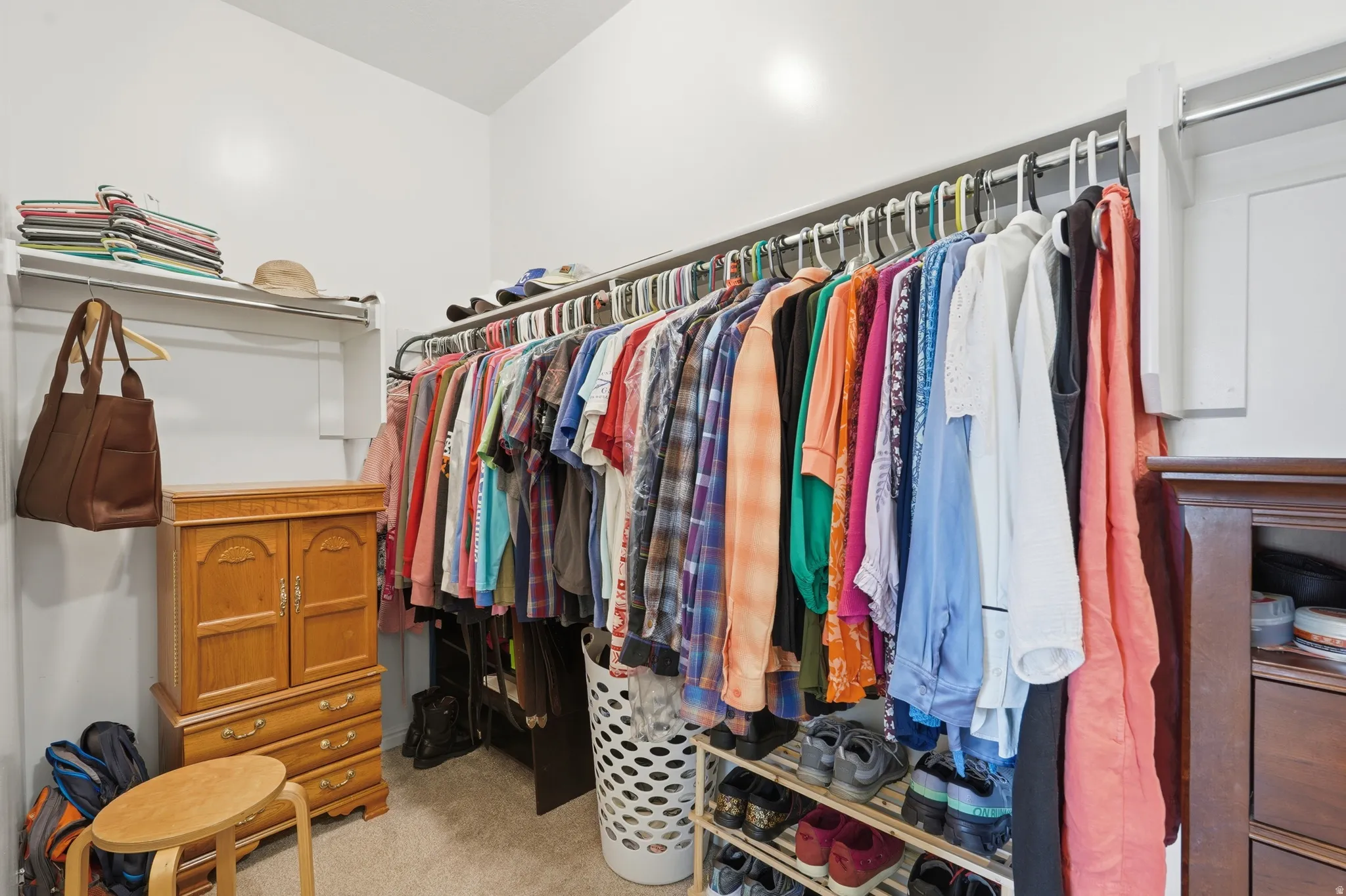 Walk in closet featuring light carpet