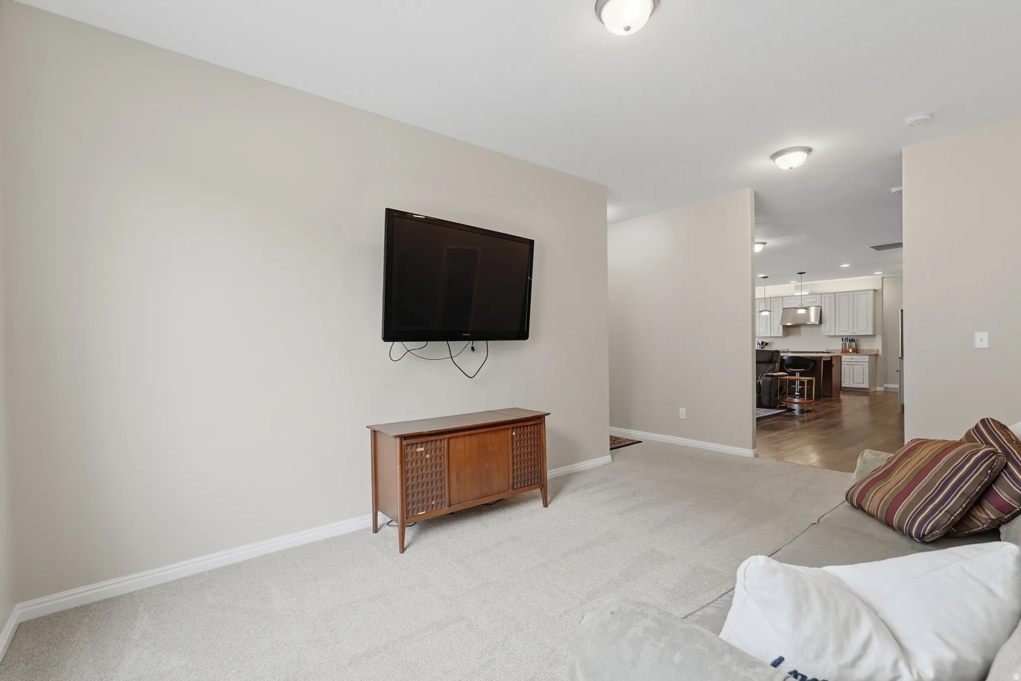 Living room with light carpet and baseboards