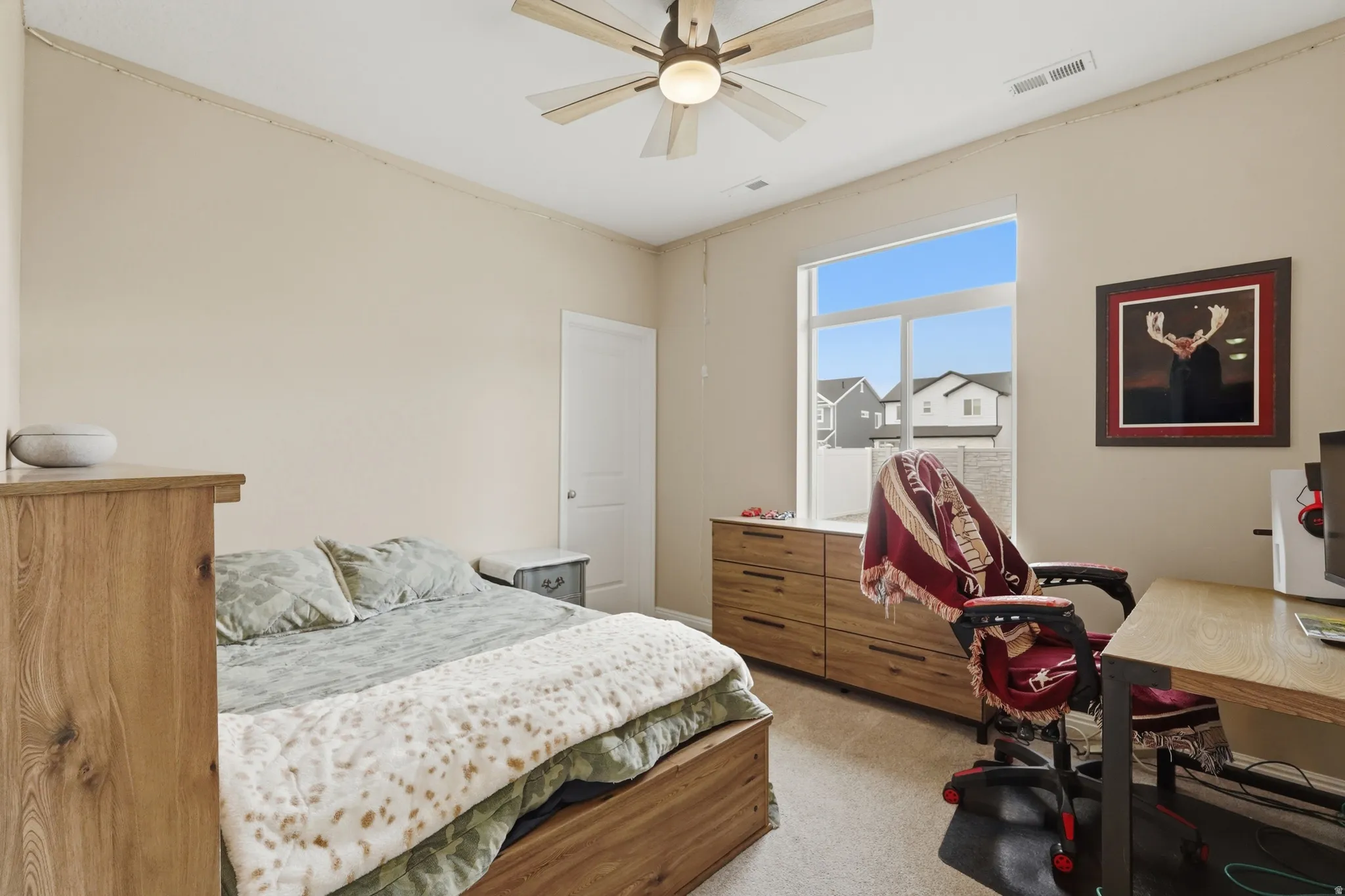 Bedroom with light carpet and ceiling fan