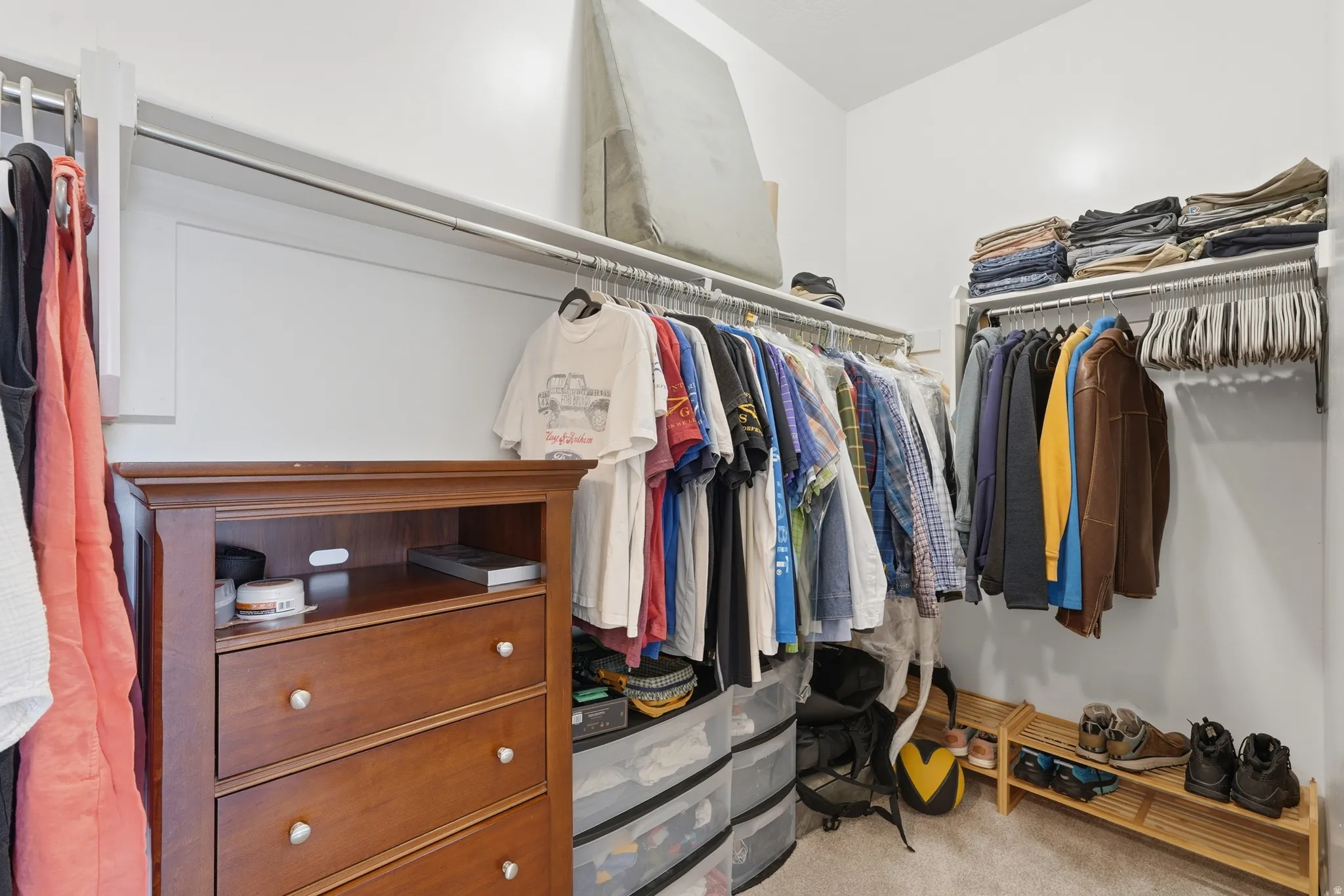 Walk in closet featuring light carpet