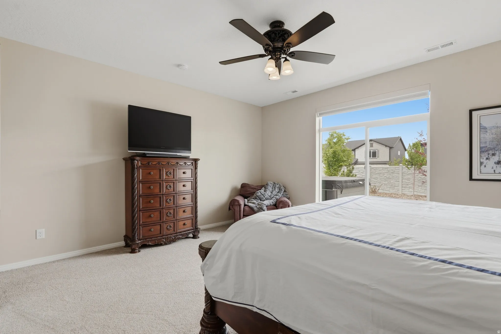 Carpeted bedroom featuring access to exterior and ceiling fan