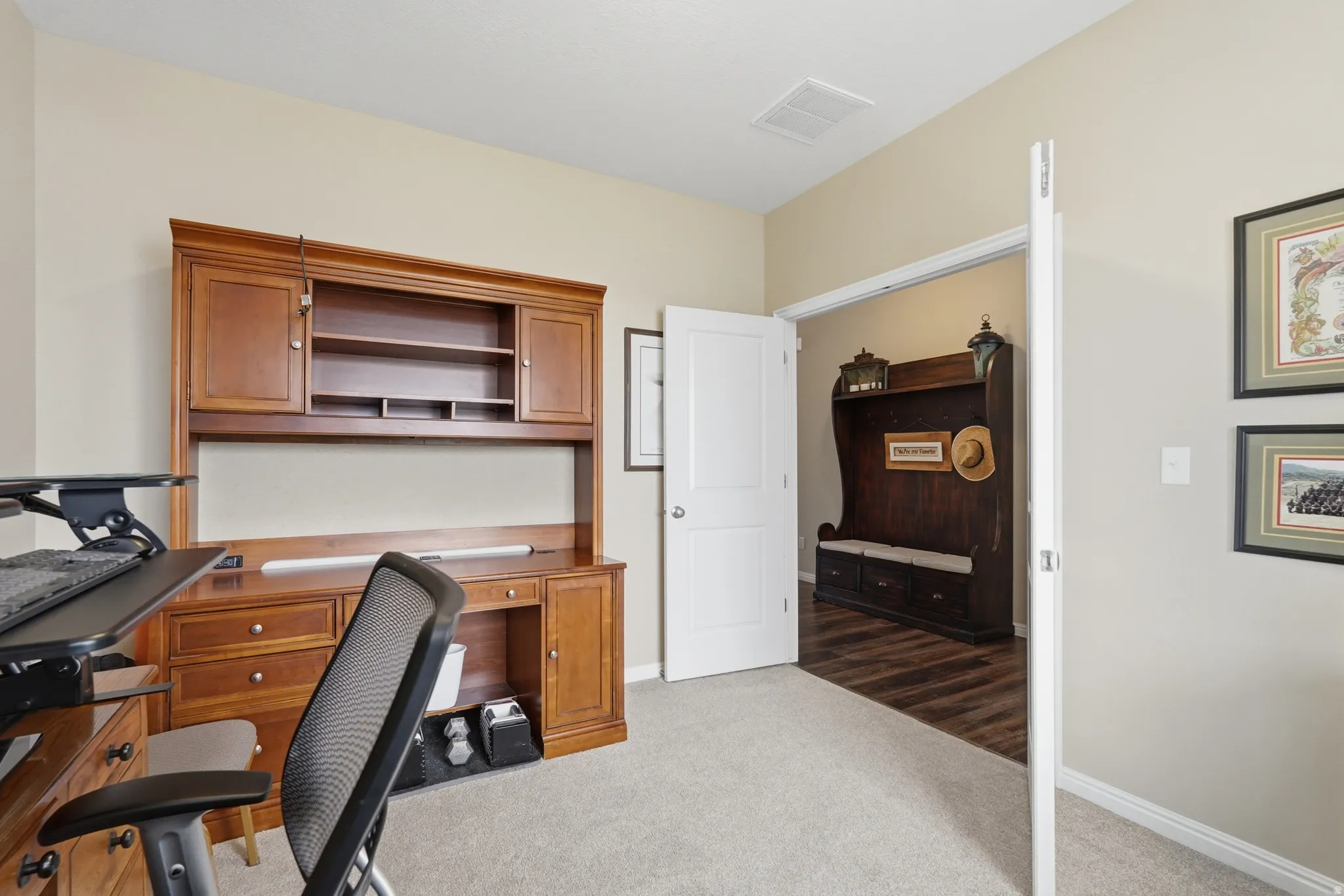 Office with light carpet and baseboards