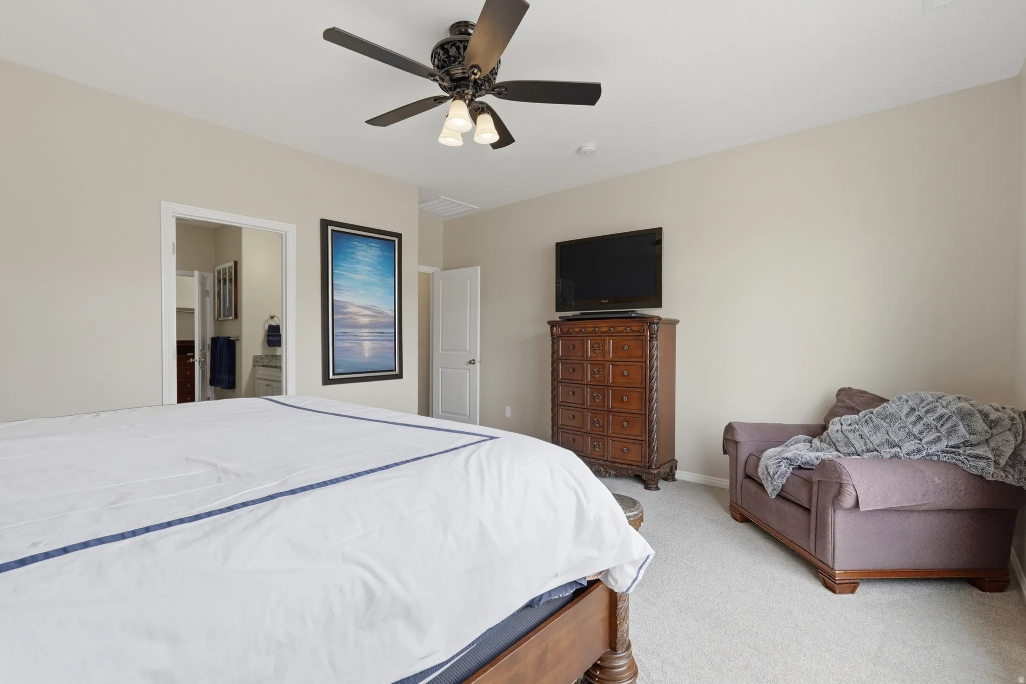 Bedroom featuring light carpet and a ceiling fan