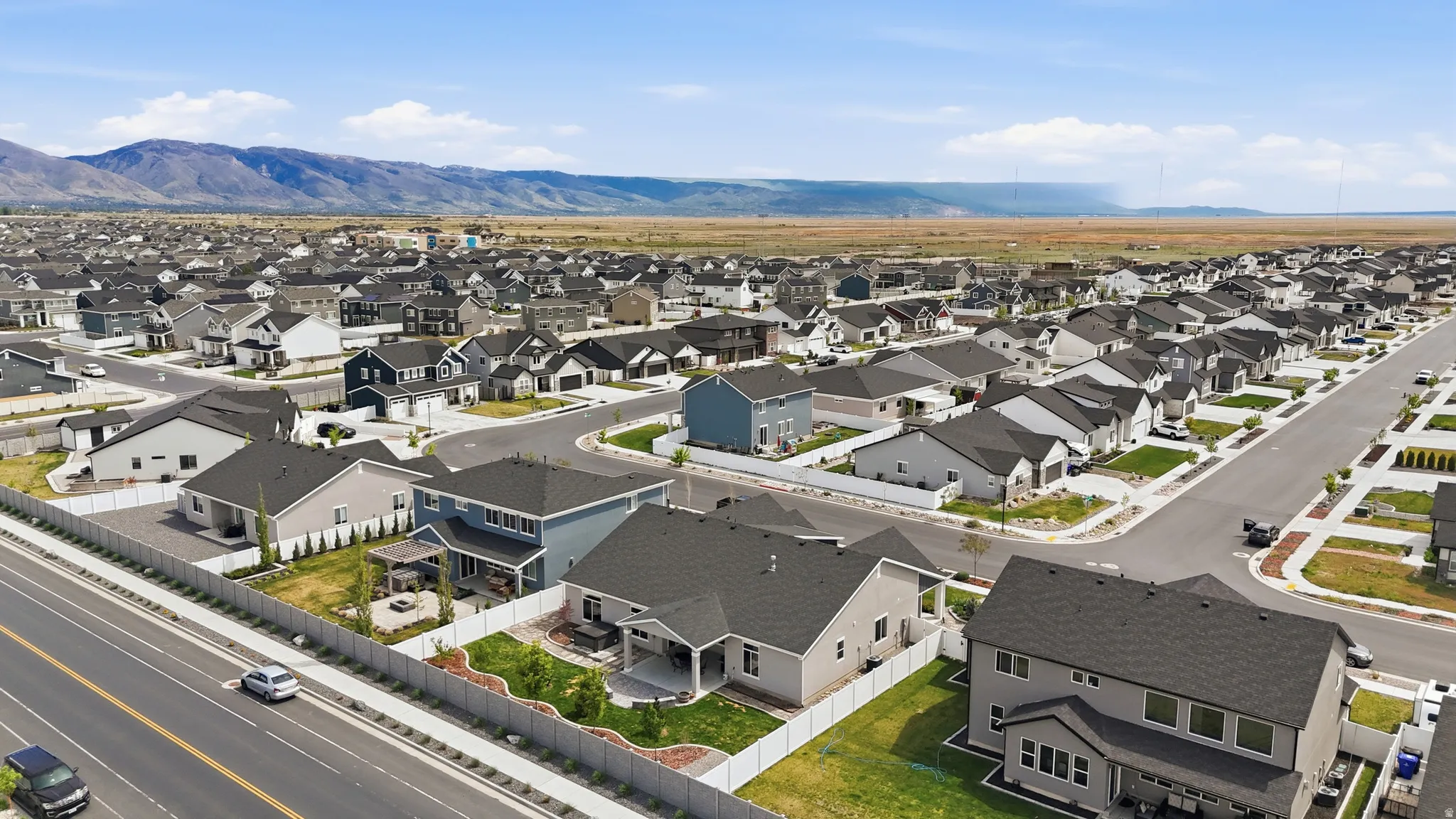 Aerial view of residential area featuring a mountainous background
