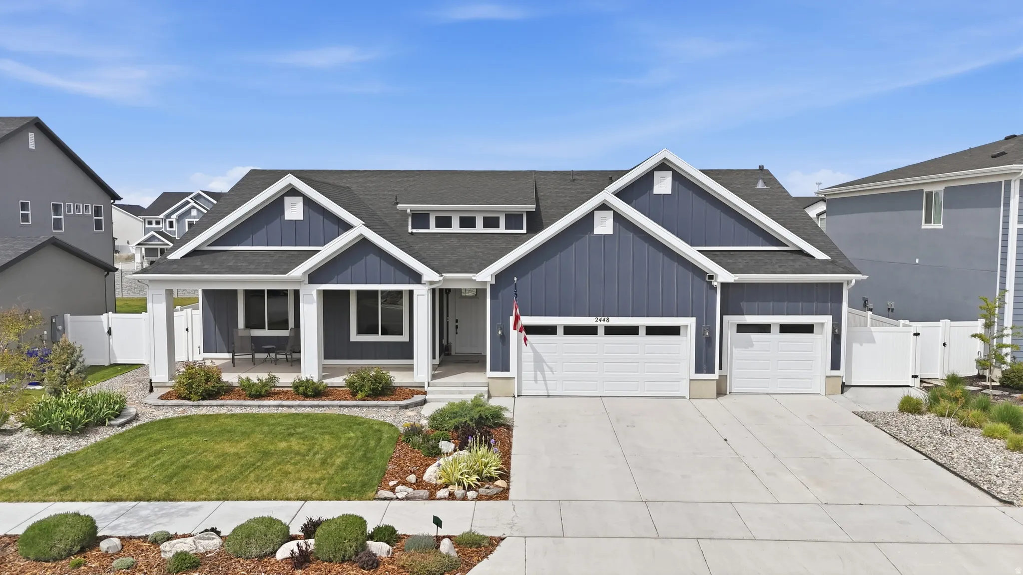 Craftsman inspired home with a gate, a porch, a shingled roof, and concrete driveway
