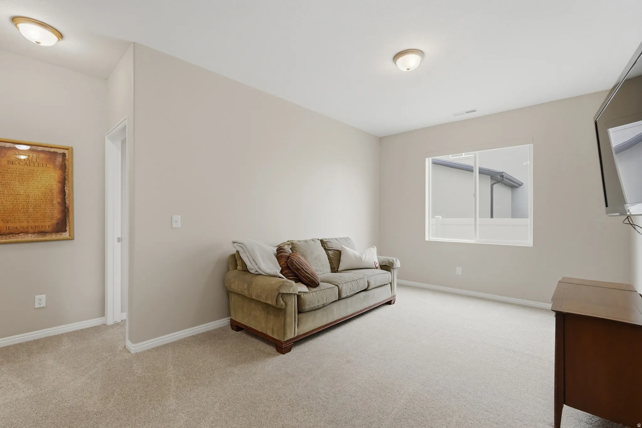 Living area featuring light carpet
