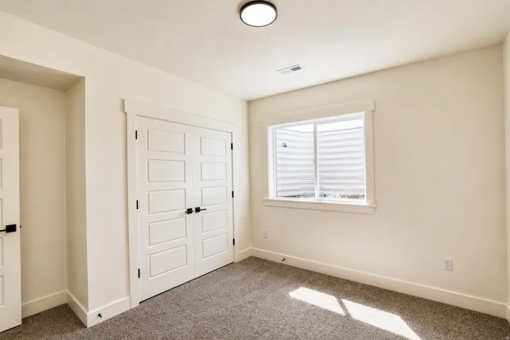 Unfurnished bedroom with a closet and carpet floors