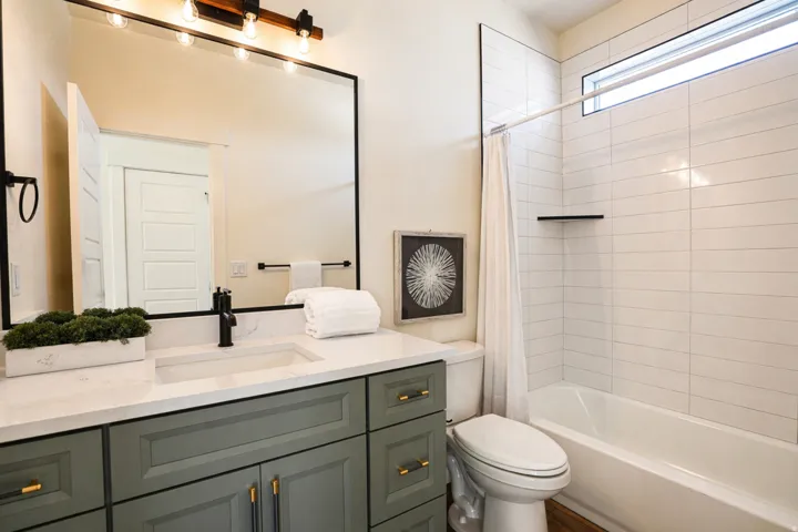 Bathroom featuring vanity and shower / bath combination with curtain