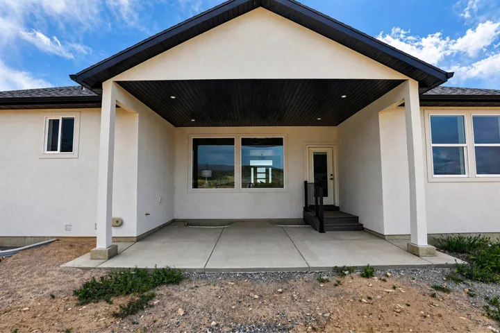 Rear view of property with a patio and stucco siding