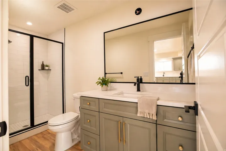 Full bath featuring vanity, light wood finished floors, a shower stall, and recessed lighting