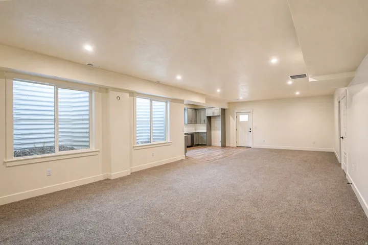 Unfurnished living room featuring recessed lighting and carpet floors
