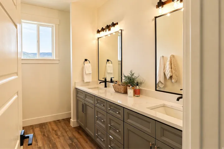 Bathroom featuring double vanity and dark wood finished floors