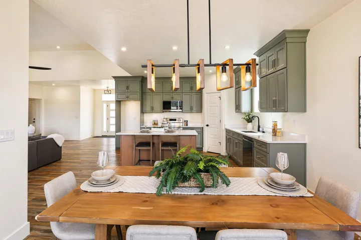 Dining area with dark wood-style floors and recessed lighting