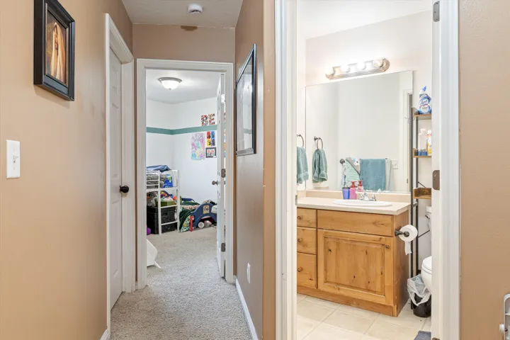 Half bath featuring vanity and light carpet