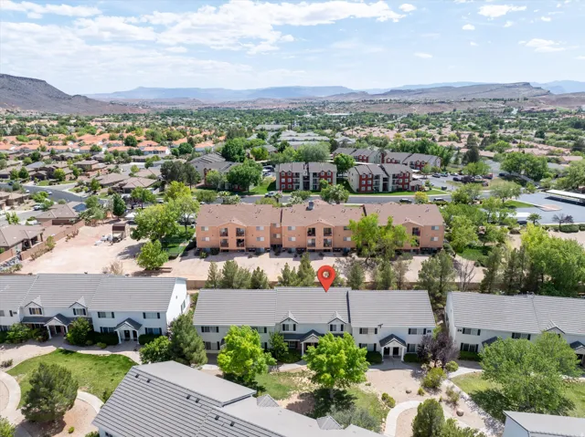 Aerial perspective of suburban area featuring a mountain backdrop