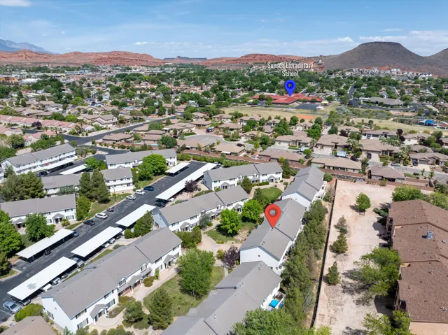 Aerial overview of property's location featuring mountains and nearby suburban area