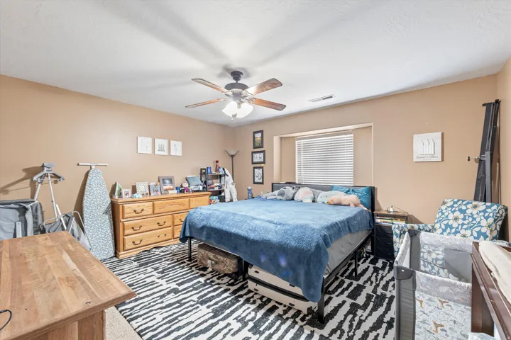Bedroom with carpet and ceiling fan