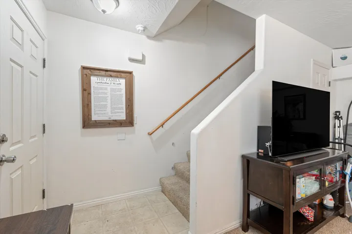 Stairway featuring baseboards and a textured ceiling