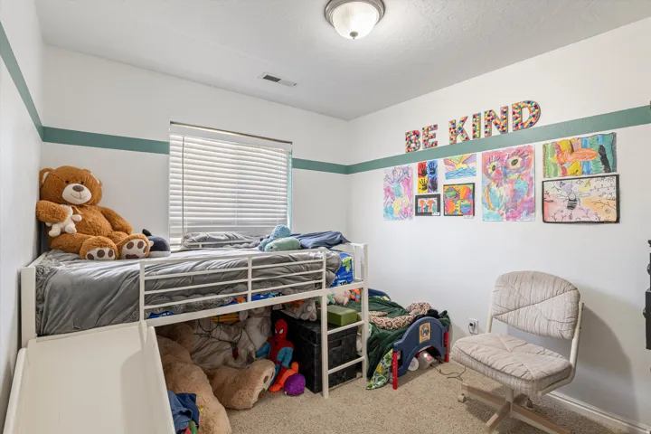 Carpeted bedroom featuring a textured ceiling