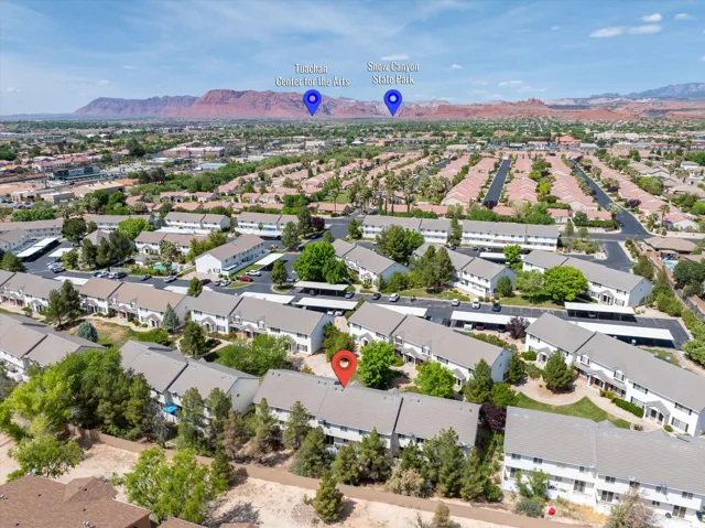 Aerial overview of property's location featuring mountains and nearby suburban area