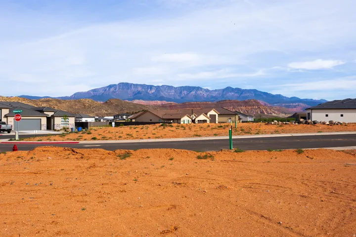 View of mountain backdrop featuring nearby suburban area