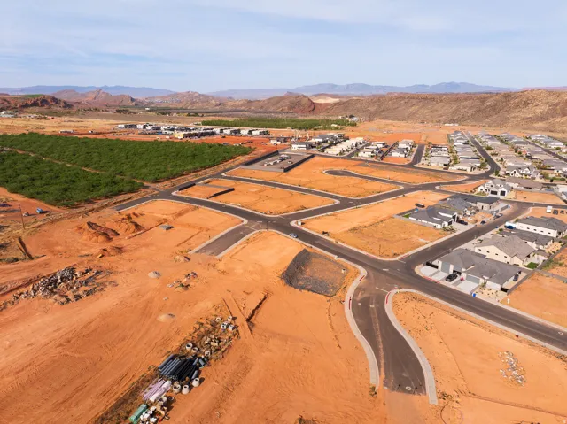 Aerial overview of property's location featuring a mountain backdrop and nearby suburban area