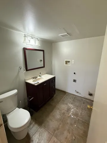Half bath featuring toilet and vanity