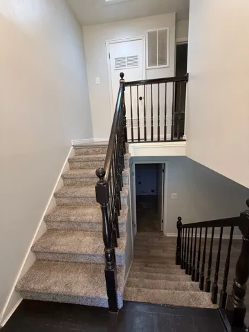 Stairway featuring wood finished floors and baseboards