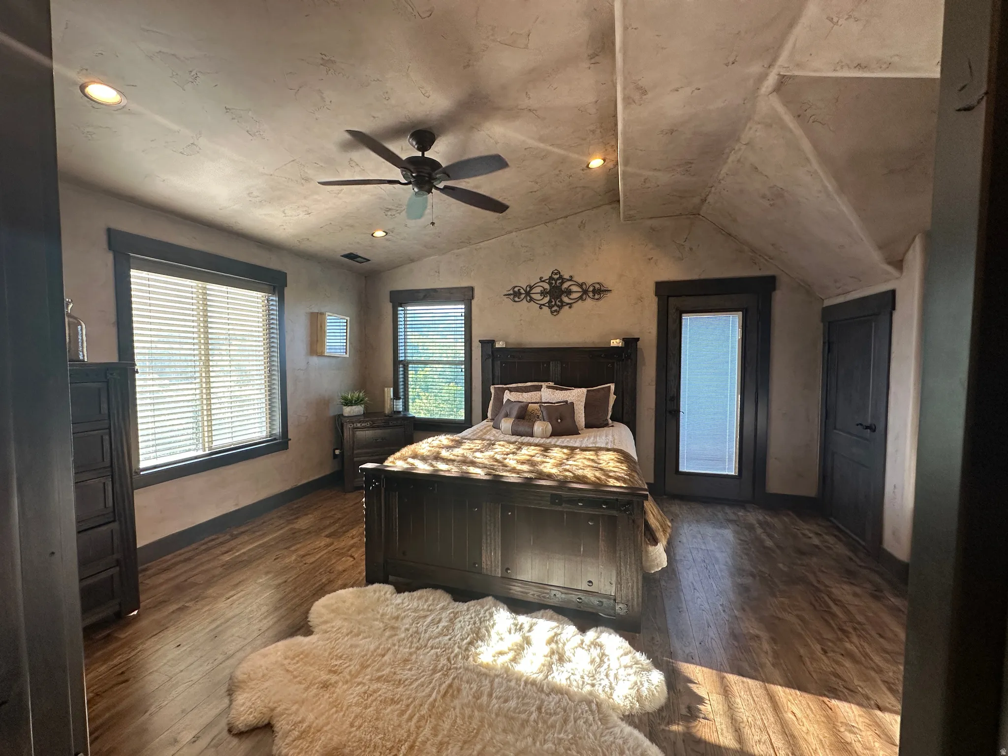 Primary Bedroom with dark wood-style flooring, a ceiling fan, and recessed lighting