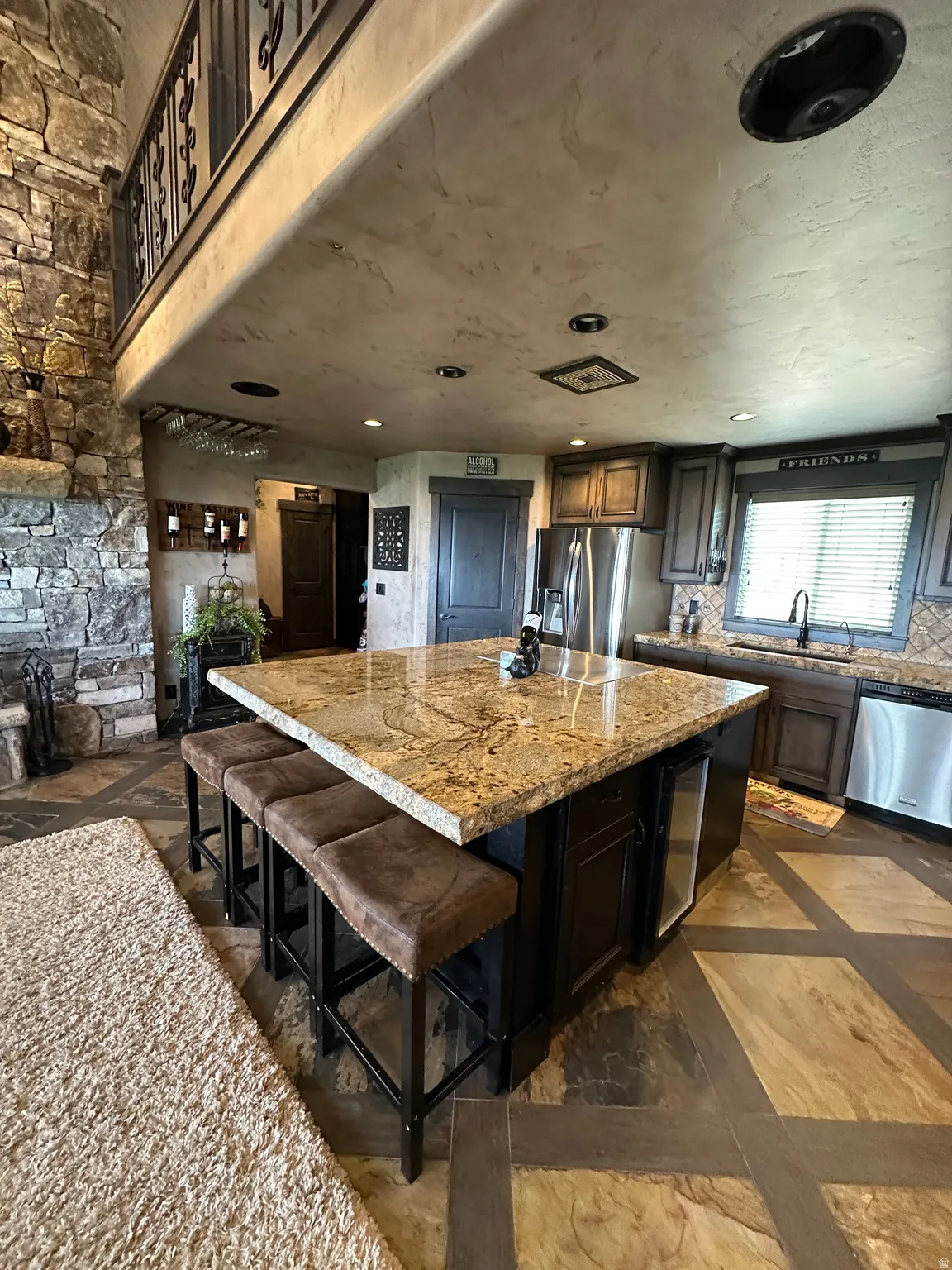 Kitchen with a breakfast bar area, a center island, stainless steel appliances, recessed lighting, and decorative backsplash