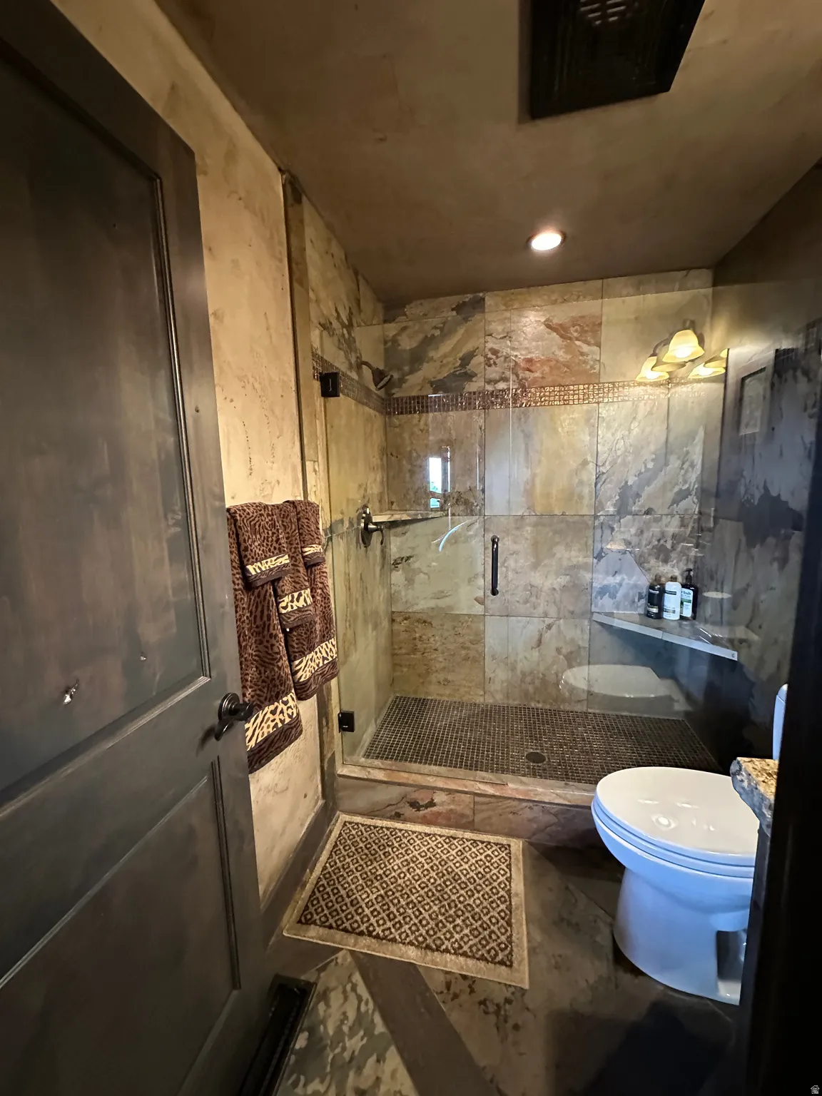 Bathroom featuring vanity and a shower and heated floors
