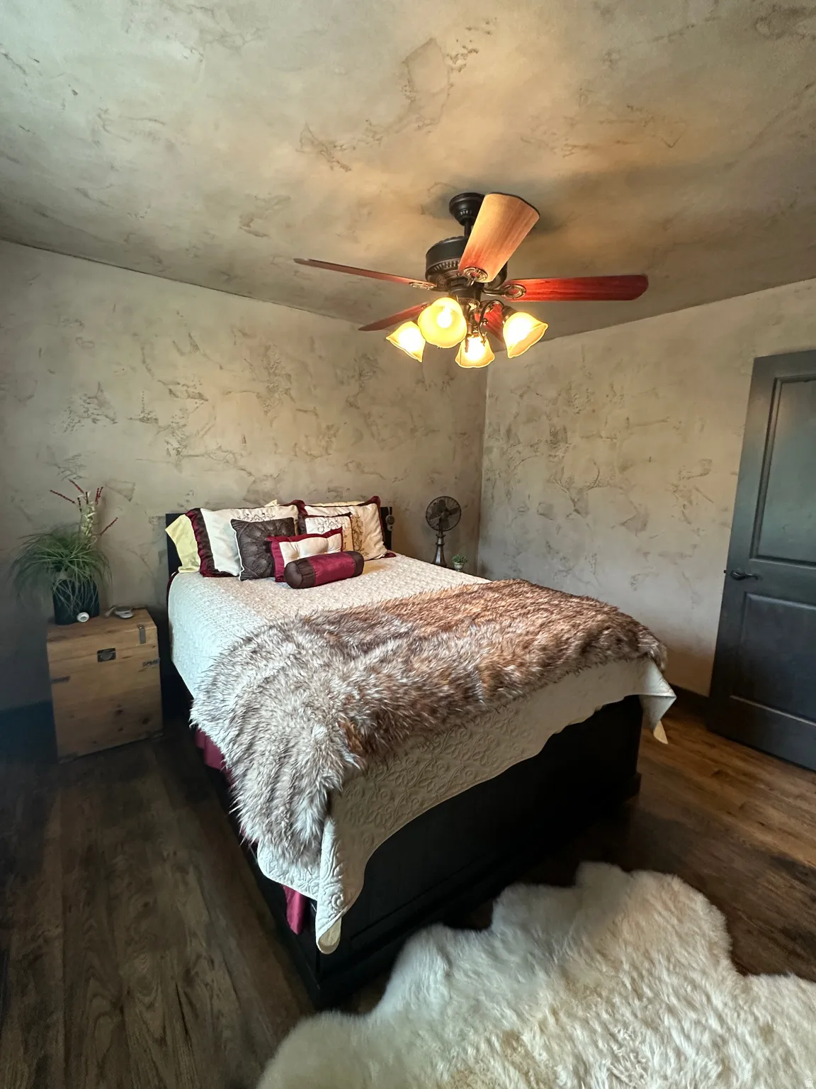 Bedroom with dark wood finished floors and ceiling fan