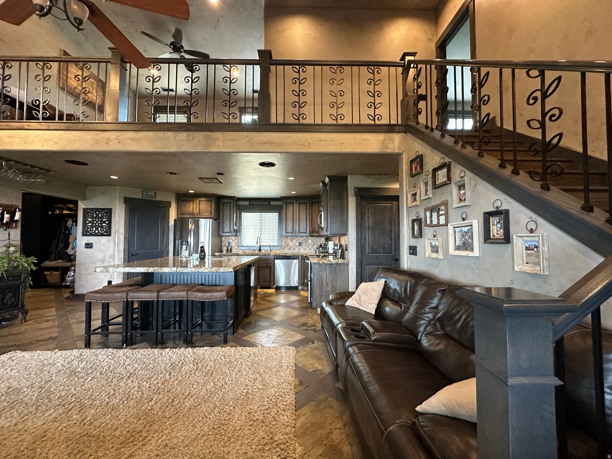 Living room featuring ceiling fan, and a high ceiling